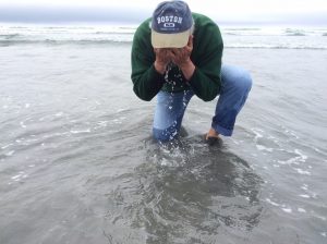 Leo washing his face in the ocean